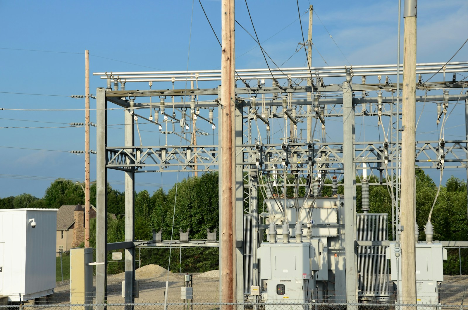 Electrical substation equipment and transformers under a blue sky